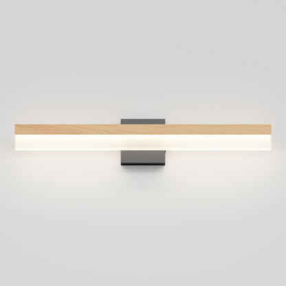 The Artika Neil modern LED bathroom vanity light features a rectangular wooden top and frosted white panel, mounted on a dark base against a light gray wall.