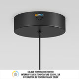 A black ceiling light fixture with a colour temperature switch, showing adjustable warm to cool light settings. Below, multilingual text reads: Colour temperature switch in English, French, and Spanish.