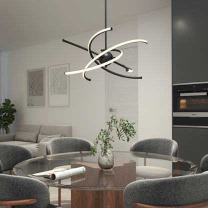 A modern dining room with a round glass table, four gray upholstered chairs, a small potted plant centerpiece, and a unique sculptural pendant light above. A sofa and wall art are visible in the background.