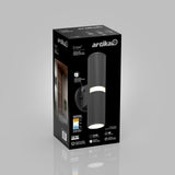 A black rectangular box for an Artika Groove wall light, featuring a photo of the cylindrical black fixture, LED details, and icons showing lighting specs. A side panel displays the lamp installed beside a doorway.