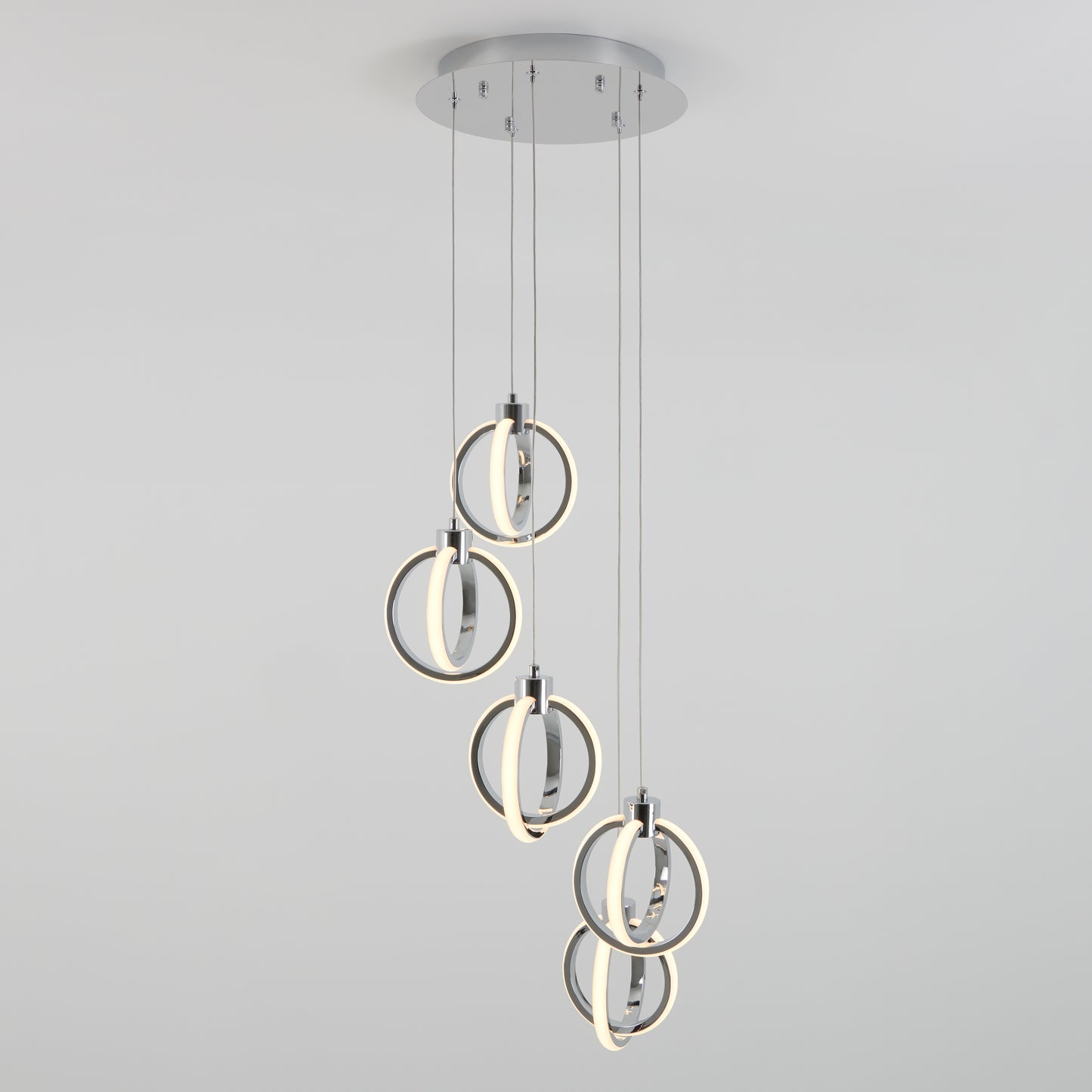 The Artika Soho modern 5-light LED pendant features five illuminated rings suspended at different heights from a round base, creating a striking contemporary ceiling light against a plain white background.
