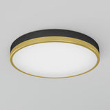 A round ceiling light fixture with a black and gold rim and a white illuminated center, mounted on a plain light gray ceiling.