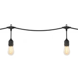 Two black string lights with exposed bulbs hanging on a wire against a white background. The bulbs are lit, emitting a warm yellow glow.