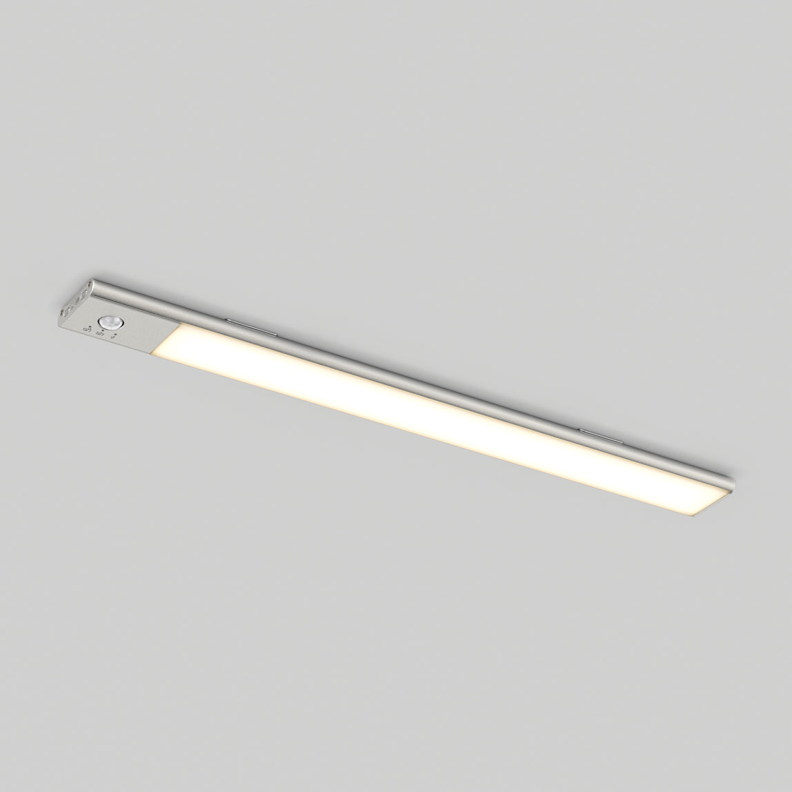 A slim, rectangular LED ceiling light with a white glow is mounted on a plain, light-colored ceiling.