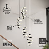 A modern staircase area with two spiral-shaped, matte black pendant lights featuring integrated LED, adjustable height, and an energy-efficient design with a 5-year warranty. No bulbs required.