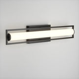 A modern wall-mounted light fixture with a horizontal cylindrical white light encased in a rectangular black metal frame, attached to a light gray wall.