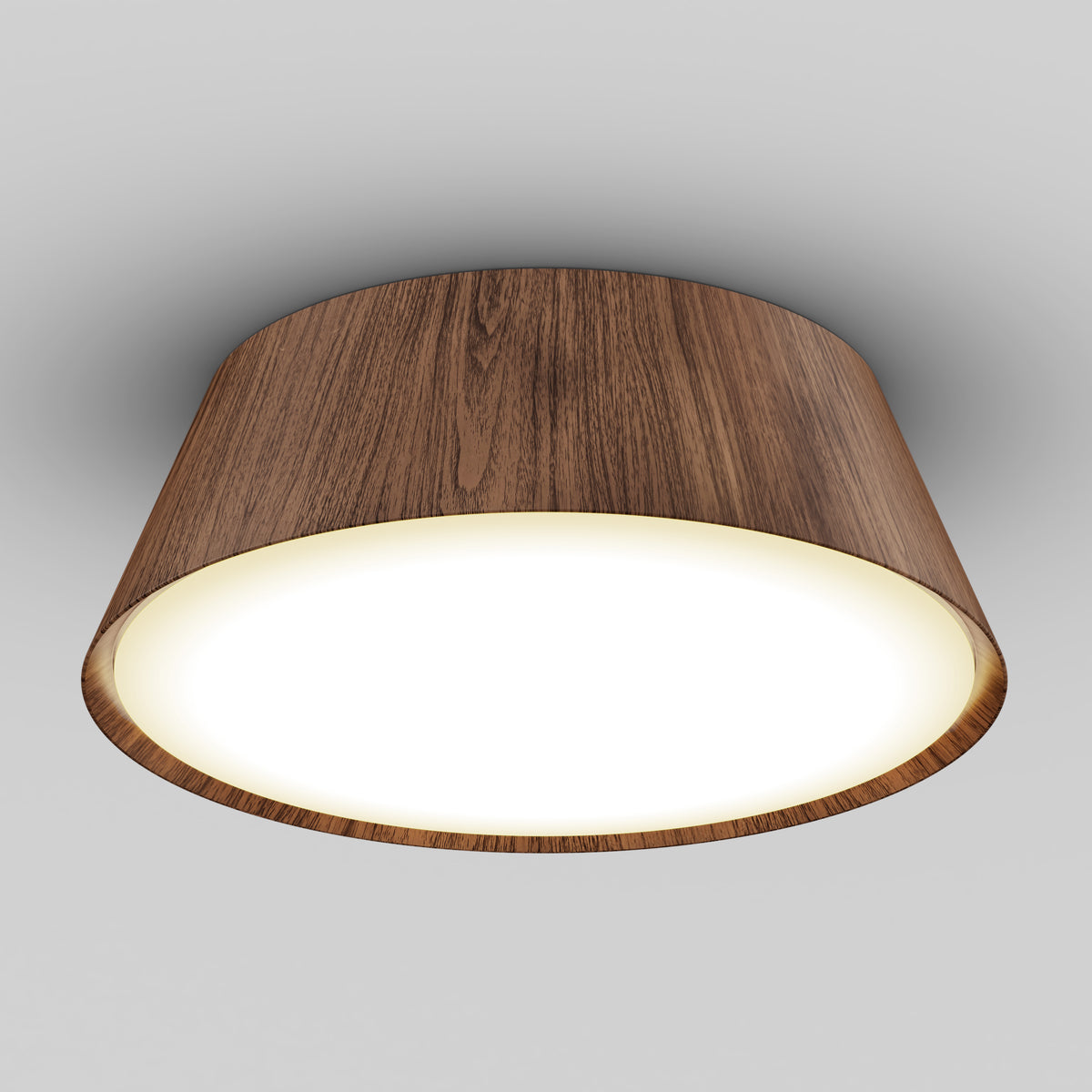 A ceiling light fixture with a circular wooden frame and a smooth white diffuser, mounted on a plain light gray ceiling. The light is turned on, emitting a soft, even glow.