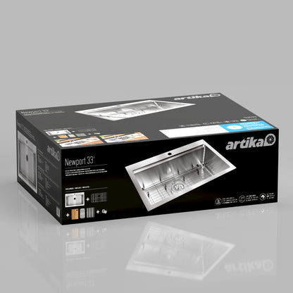 A rectangular box on a reflective surface shows Artika branding and images for the Newport single bowl stainless steel workstation sink, with product features in white, blue, and black.