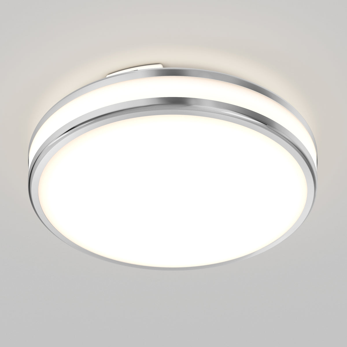 The Artika Hemisphere 15 in. LED flush mount light features a modern round design with chrome trim, five selectable color temperatures (CCT), adjustable brightness, and a white illuminated center, perfect for smooth white ceilings.
