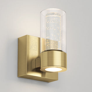 Artika's Essence 1-light LED vanity features a brushed gold finish and clear bubble glass—ideal accent lighting for light walls.