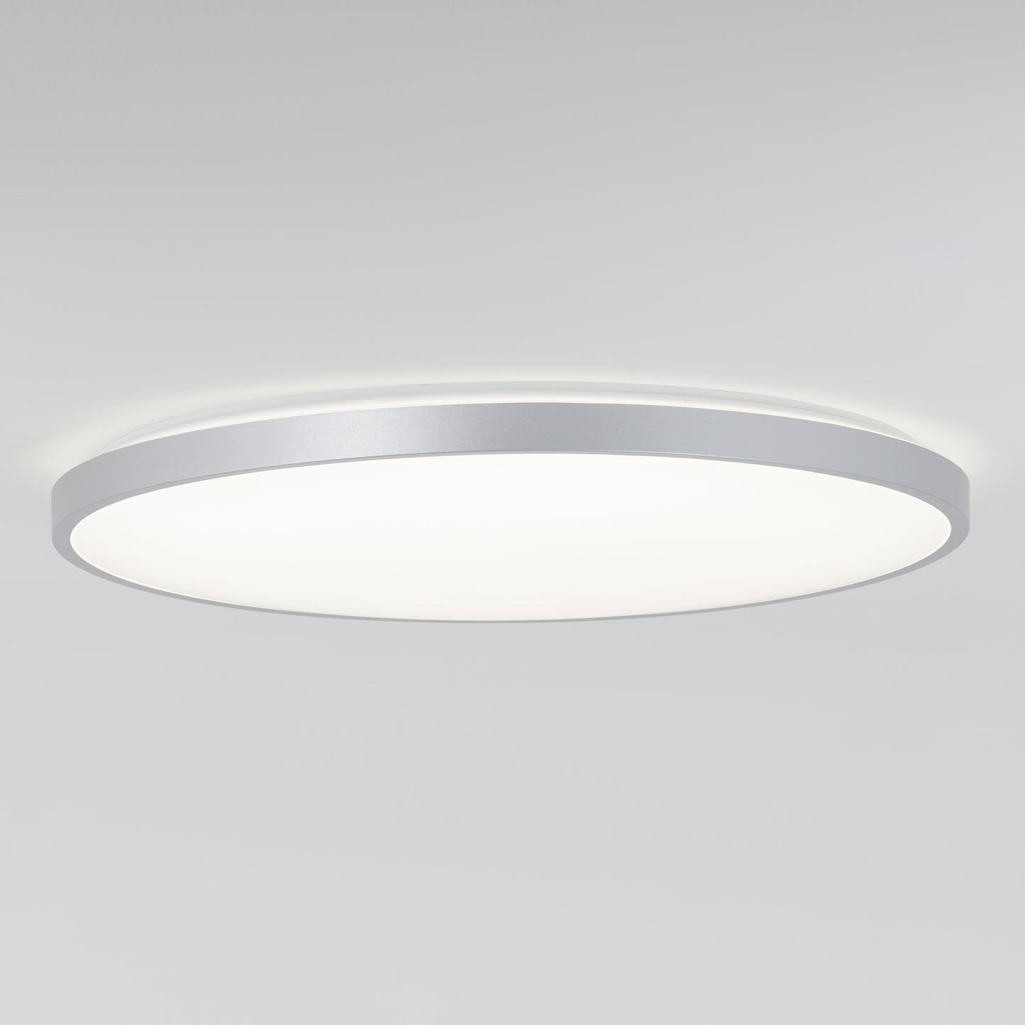 The Artika Europa 21 in. LED modern flush mount light features a slim silver rim and emits soft, even white light. This contemporary ceiling fixture comes with a remote for easy control and suits any plain white ceiling.