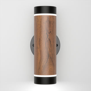 The Artika C7 indoor-outdoor LED wall light 3 CCT features a modern cylindrical design with a wood grain center, black metal ends, and glowing white bands at the top and bottom, mounted on a white wall.