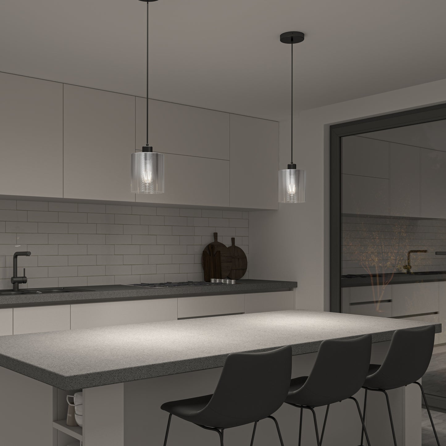 Modern kitchen with gray countertops, three black chairs at an island, white cabinetry, subway tile backsplash, and two Artika Haze glass pendant lights above the island. A black faucet and cutting boards sit on the counter.