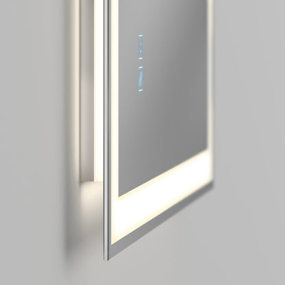 The Artika Sofia LED mirror 3 CCT with defogger features a sleek, minimalist design, touch-sensitive blue icons, and a white illuminated border. Mounted on a light gray wall, this modern mirror offers adjustable lighting for any space.