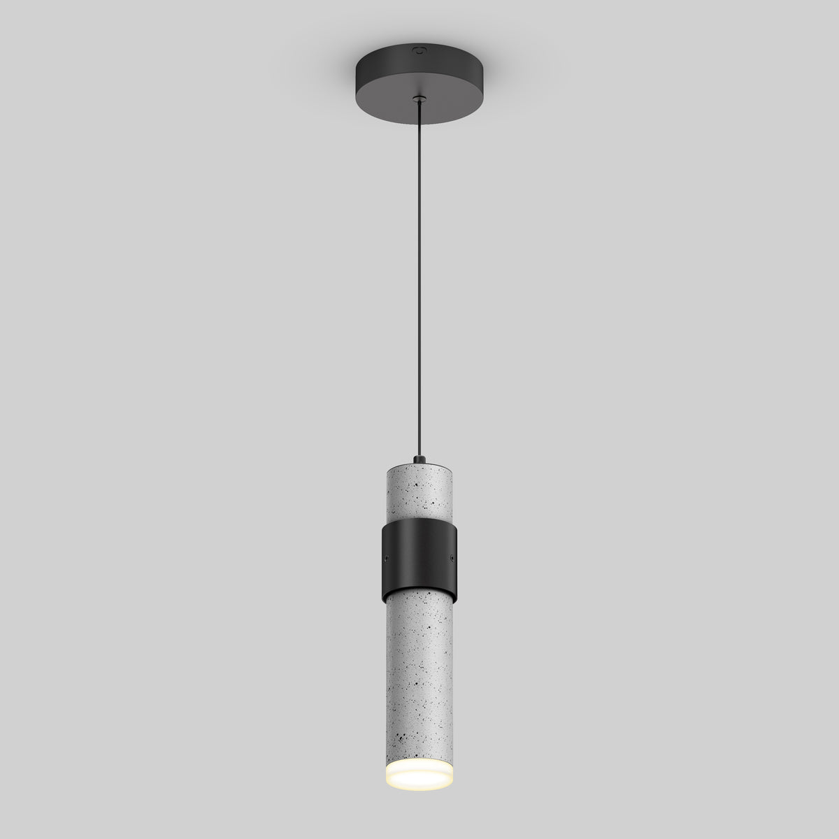 A modern cylindrical pendant light with a concrete finish, suspended by a thin black cord from a round ceiling mount. The light is illuminated, casting a soft glow downward.