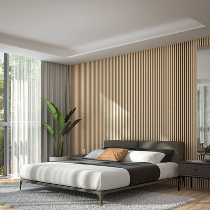 Modern bedroom with a low bed, gray bedding, and an orange pillow, set against a wall with vertical wood paneling. Large window with curtains lets in natural light. A potted plant and bedside tables complete the decor.