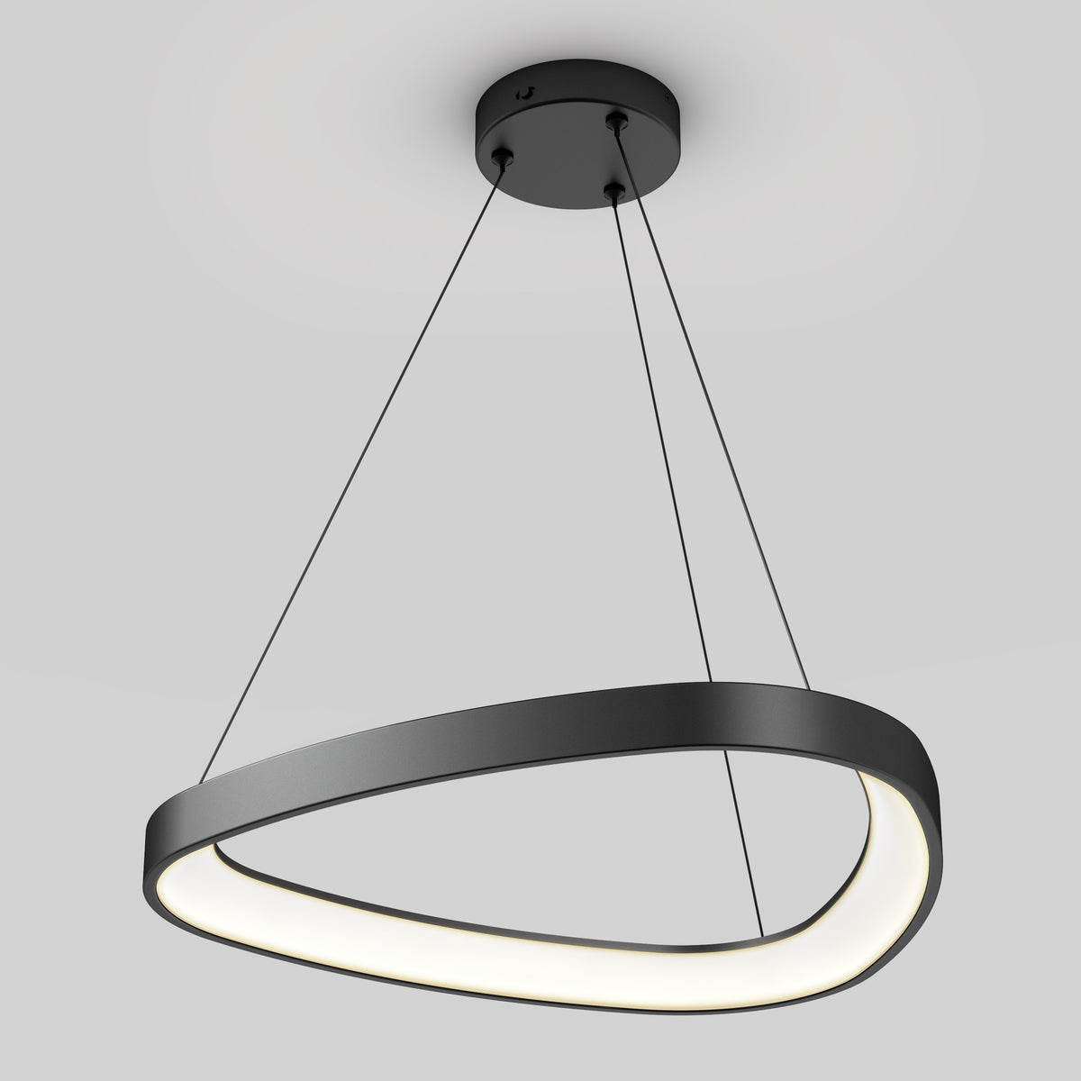 A modern, black, oval-shaped pendant light fixture hangs from the ceiling by three thin cables, emitting a soft white glow. The fixture has a sleek and minimalistic design against a light gray background.