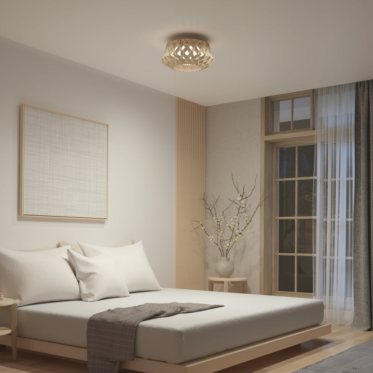 A minimalist bedroom features a low wooden bed, white bedding, and neutral decor. The Artika Kiran 13 in. modern LED flush mount light adds style overhead, while a vase with branches and framed artwork create calm serenity.