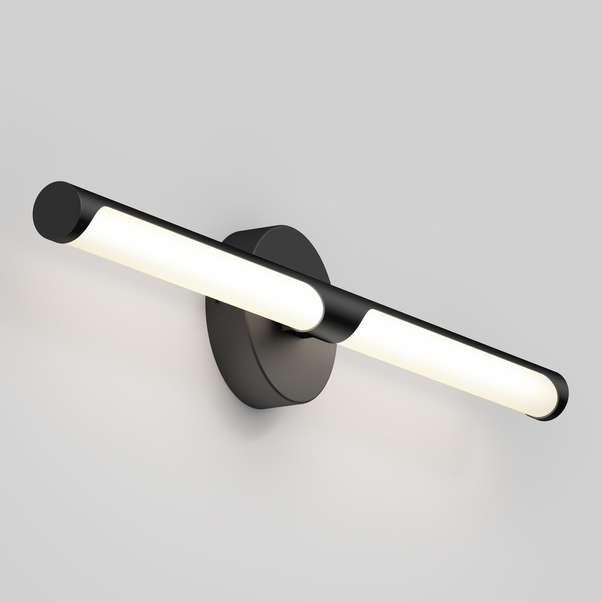 A modern black wall-mounted light fixture with a central round base and a horizontal, tubular light bar emitting a soft white glow, set against a plain light gray background.