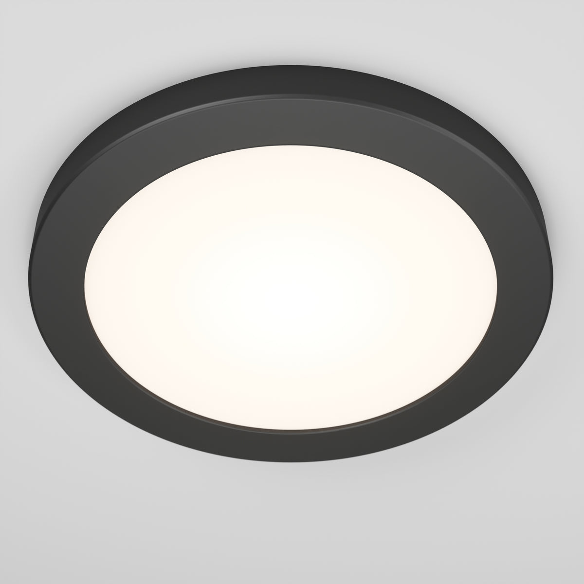 The Artika Europa Disk 7 in. LED modern flush mount light features a round design with a dark frame and bright white center, seamlessly mounted to a plain white ceiling. It offers 3 CCT options for versatile lighting.