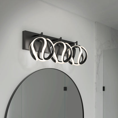 The Artika Vivaldi LED contemporary bathroom vanity light features three abstract, looped LED lights with black frames on a rectangular black base, adding modern style above your mirror.