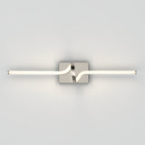 A modern wall-mounted light fixture with a central square base and a wavy metallic accent, supporting a horizontal, tubular LED light bar on a plain light gray background.