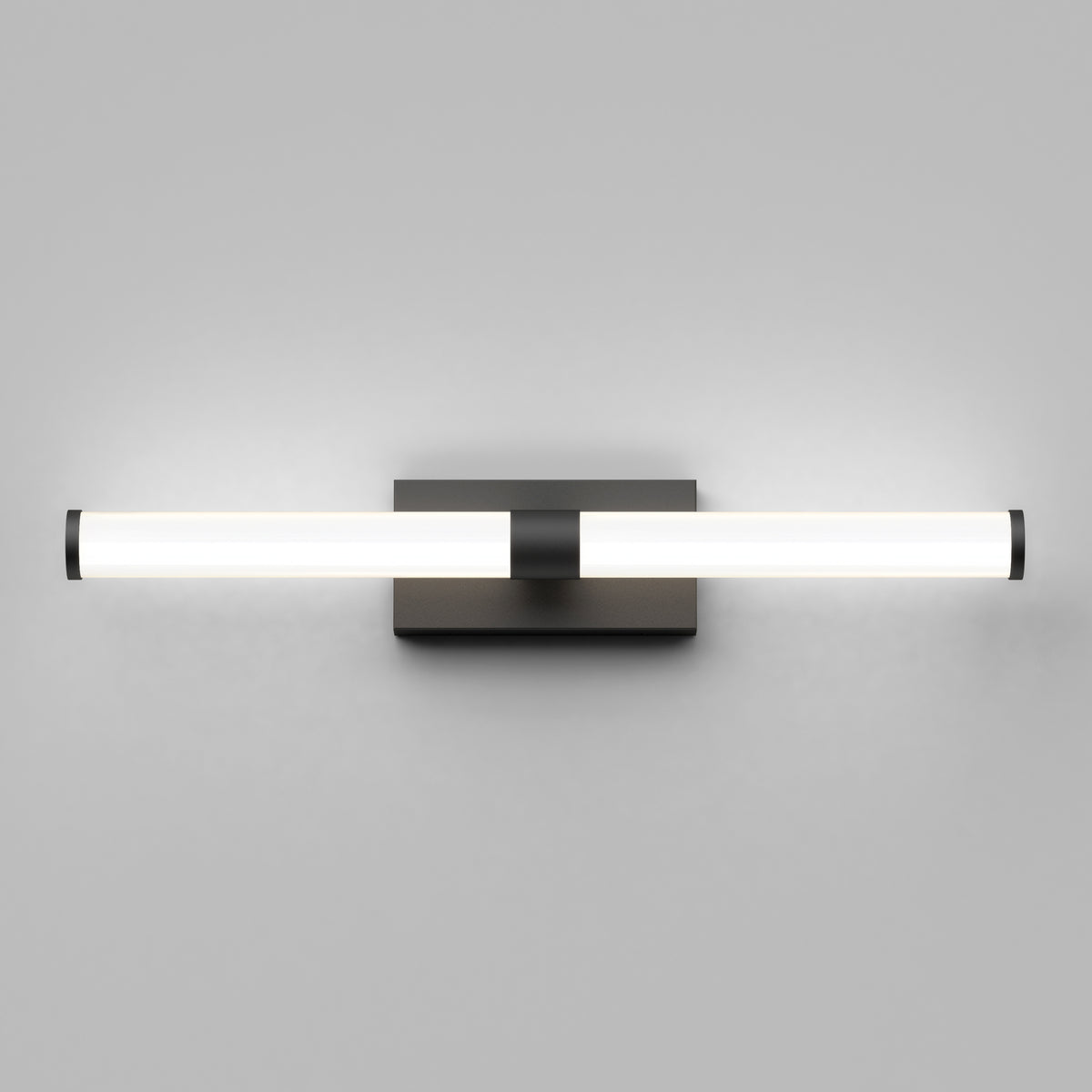The Artika Vitoro modern LED bathroom vanity light features a horizontal cylindrical frosted glass shade with black metal accents, mounted on a square black base against a plain light gray wall.