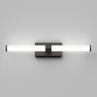 The Artika Vitoro modern LED bathroom vanity light features a horizontal cylindrical frosted glass shade with black metal accents, mounted on a square black base against a plain light gray wall.
