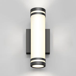 The Artika Bradley modern LED indoor-outdoor wall light 3 CCT features a cylindrical design with a frosted white center, black metal ends, and a square black base, casting light both upward and downward.