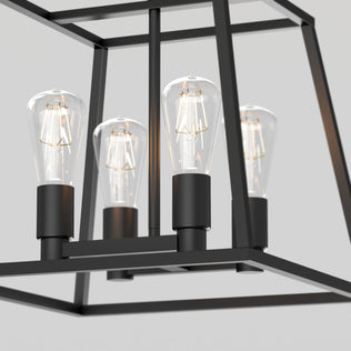 Close-up of four bulbs in the Carter Square 4-light chandelier by Artika, featuring a modern black metal geometric frame.