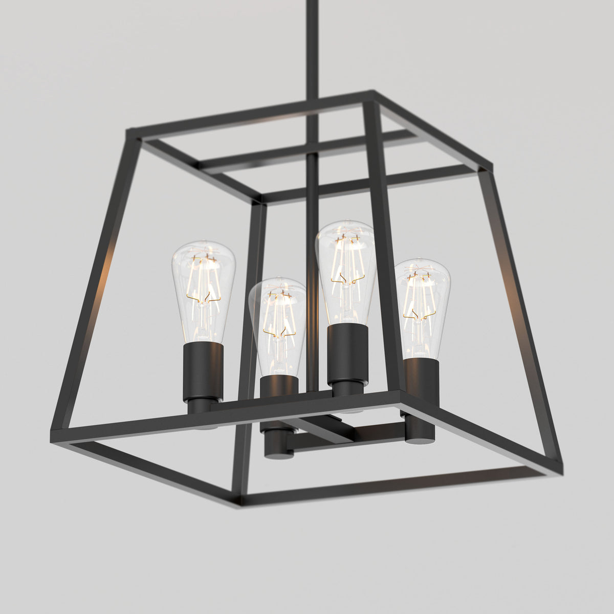 The Artika Carter Square 4-light chandelier is a modern black metal pendant featuring a geometric open-cube frame with four exposed bulbs, shown against a plain light gray background.