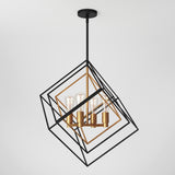 A modern geometric pendant light fixture with black and gold intersecting square frames, featuring four exposed light bulbs at the center, suspended from a black ceiling mount.