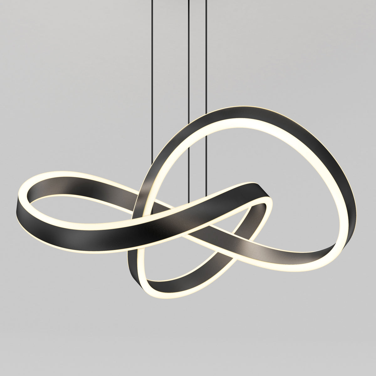 A modern pendant light with intertwined, looped LED strips in a black and white finish, suspended from the ceiling by three thin cables against a plain gray background.