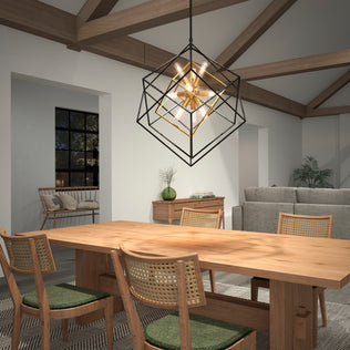 Modern dining room with wooden table, four chairs, and Artika’s Imperium 9-light chandelier glowing through the night window.