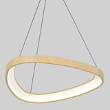 A modern, asymmetrical ring-shaped pendant light with a wooden finish, suspended by three thin black wires against a plain light gray background. The inner side of the ring emits a soft white glow.