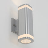 A modern wall-mounted cylindrical light fixture made of brushed metal, featuring illuminated bands at the top and bottom, attached to a rectangular wall plate against a plain light-colored background.