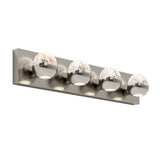 A modern wall-mounted light fixture with a brushed metal rectangular base and four globe-shaped glass lights evenly spaced along the base, each emitting a soft white glow.