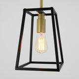 A modern pendant light fixture with a black metal geometric frame, a brass socket, and an exposed vintage-style Edison bulb, hanging against a plain white background.