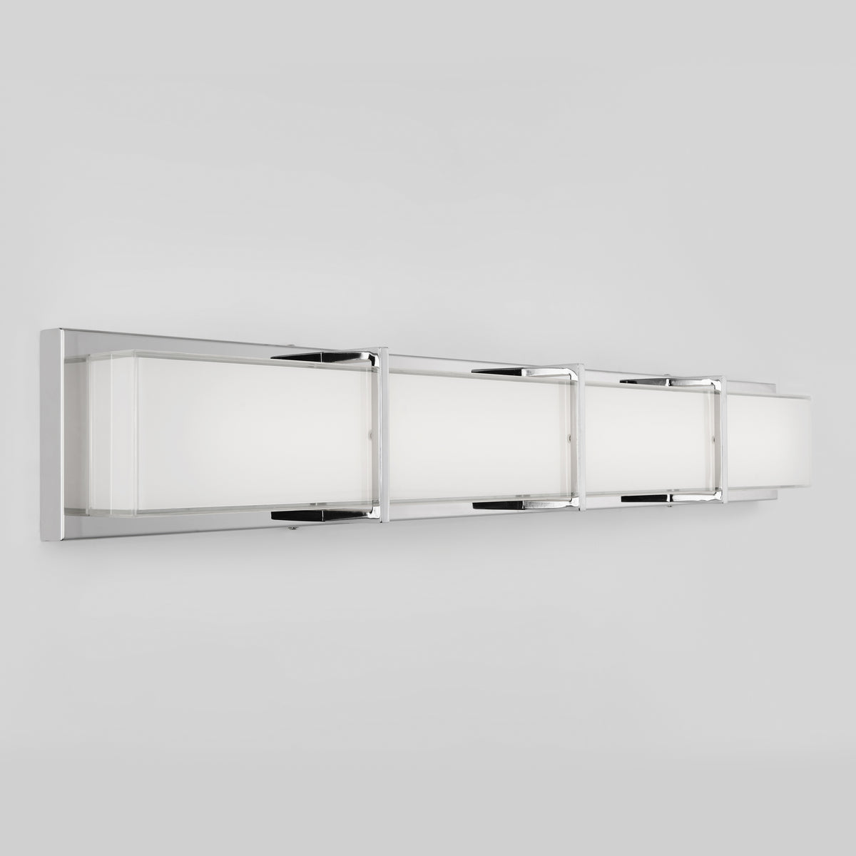 A modern wall-mounted light fixture with a long, rectangular shape, featuring a chrome frame and frosted white glass panels, designed for contemporary interiors.