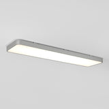 A rectangular, modern ceiling light fixture with rounded corners emits a bright, even white light against a plain white ceiling.