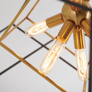 Close-up of Artika’s Imperium 9-light chandelier featuring exposed bulbs and gold framing in a sleek modern design.