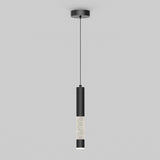 A modern pendant light with a black cylindrical fixture, hanging from a thin black cord, featuring a section with a textured or crystal-like surface near the bottom, set against a plain gray background.