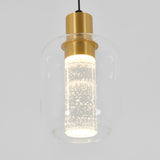 A modern pendant light with a clear glass shade, a cylindrical inner diffuser filled with bubbles, and gold metal accents, suspended by a black cord against a plain light background.