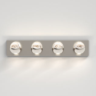 The Artika Oracle 4 light LED bathroom vanity light features round glass bulbs on a metallic base, ideal for modern bathroom walls.