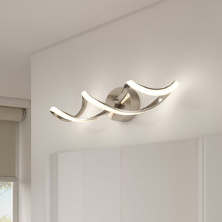 The Artika Swirl LED bathroom vanity light features two curved LED bars on a round metallic base, emitting soft white light and creating a modern look for contemporary rooms.