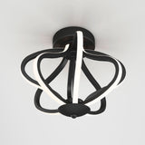 A modern ceiling light fixture with a black circular base and curved, petal-like LED light strips forming an abstract, open cage design, mounted on a white ceiling.