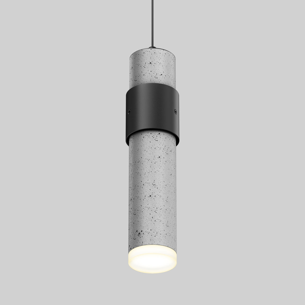 A modern cylindrical pendant light with a speckled concrete finish, black metal accent band, and a glowing white bottom, suspended by a thin black cord against a plain gray background.