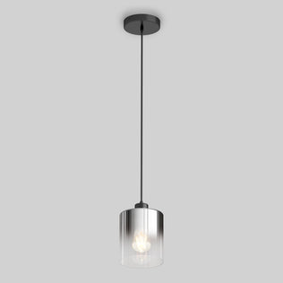 The Artika Haze pendant light features a clear cylindrical glass shade, visible bulb, and black cord with ceiling mount, shown against a plain gray background.