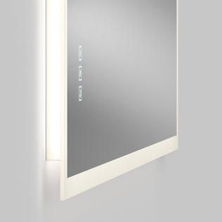 A close-up of the Artika Mavis 48" x 36" Rectangular LED Mirror, featuring a white frame, built-in side LED lights, defogger, and three touch control buttons visible on its surface.