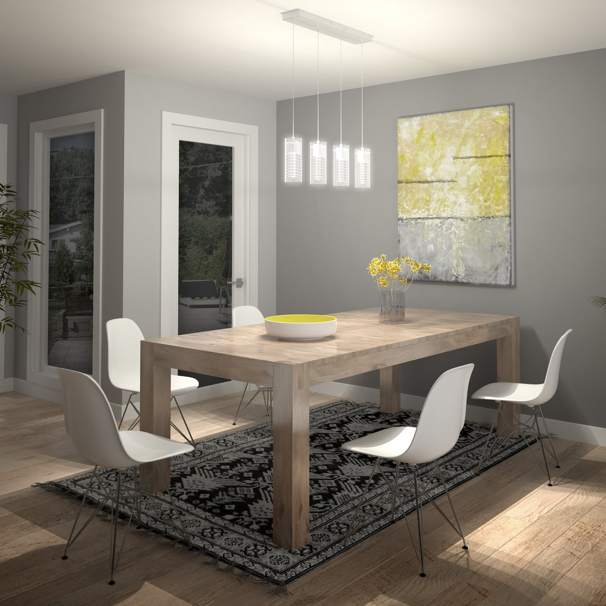 Modern dining room with a wooden table, four white chairs, a black and white patterned rug, a vase with yellow flowers, large abstract artwork, and pendant lights. Window and glass door reveal greenery outside.